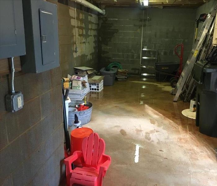 Water pooled on the concrete floor of a basement